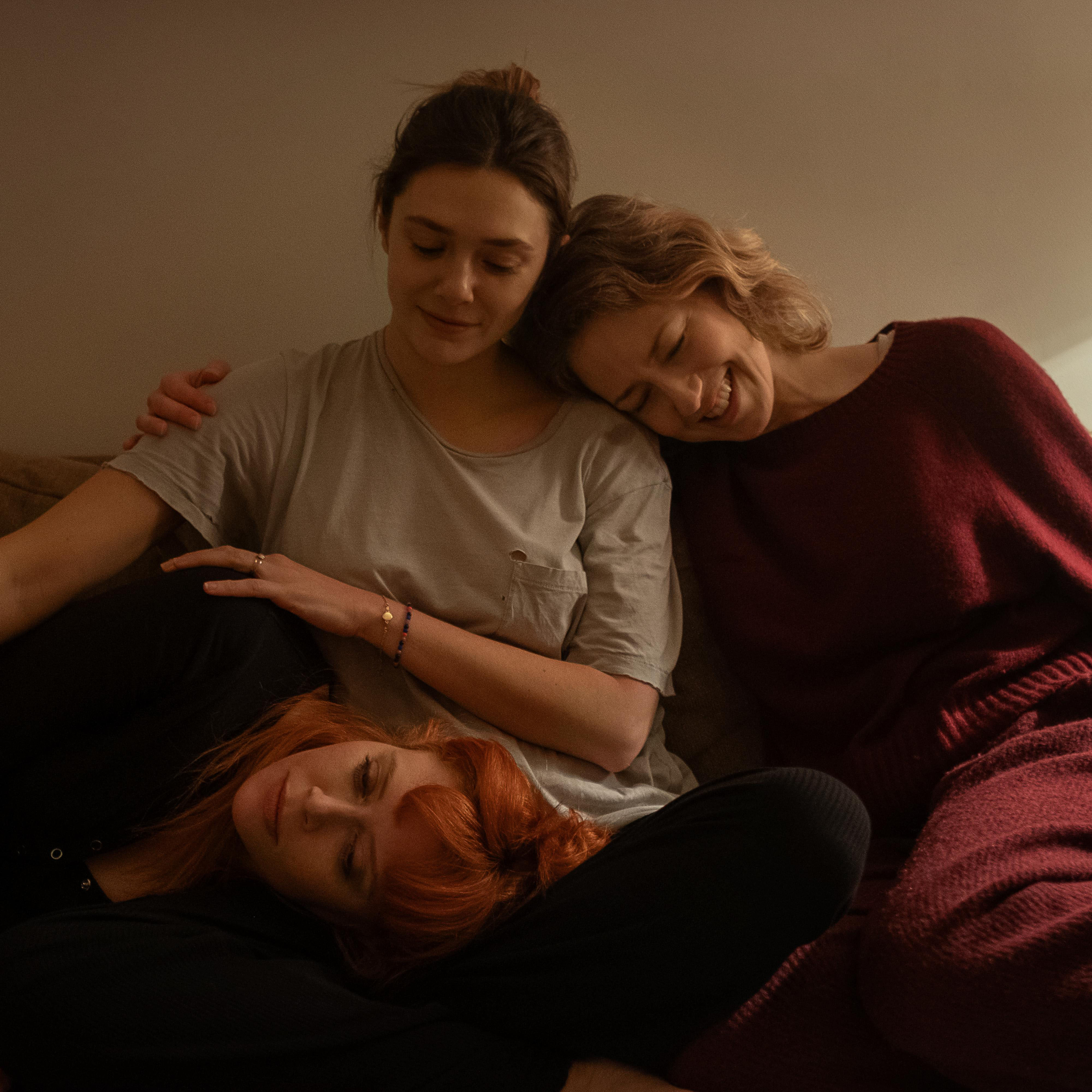 three women together on a sofa